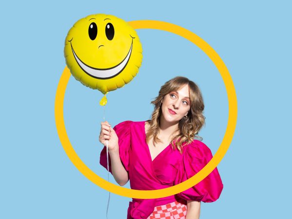 actually-good-woman-standing-with-smiley-face-balloon-in-her-hand-bondi-festival-letter-o