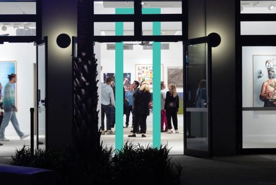 waverley-art-prize-2023-people-standing-in-art-gallery-discussing-art-shot-from-outside-door-bondi-festival-letter-i