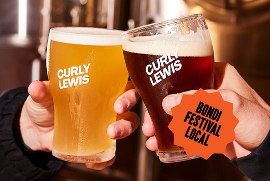 brewery-night-tours-at-curly-lewis-brewing-co-two-curly-lewis-pints-being-clinked-together-bondi-festival-local-sticker